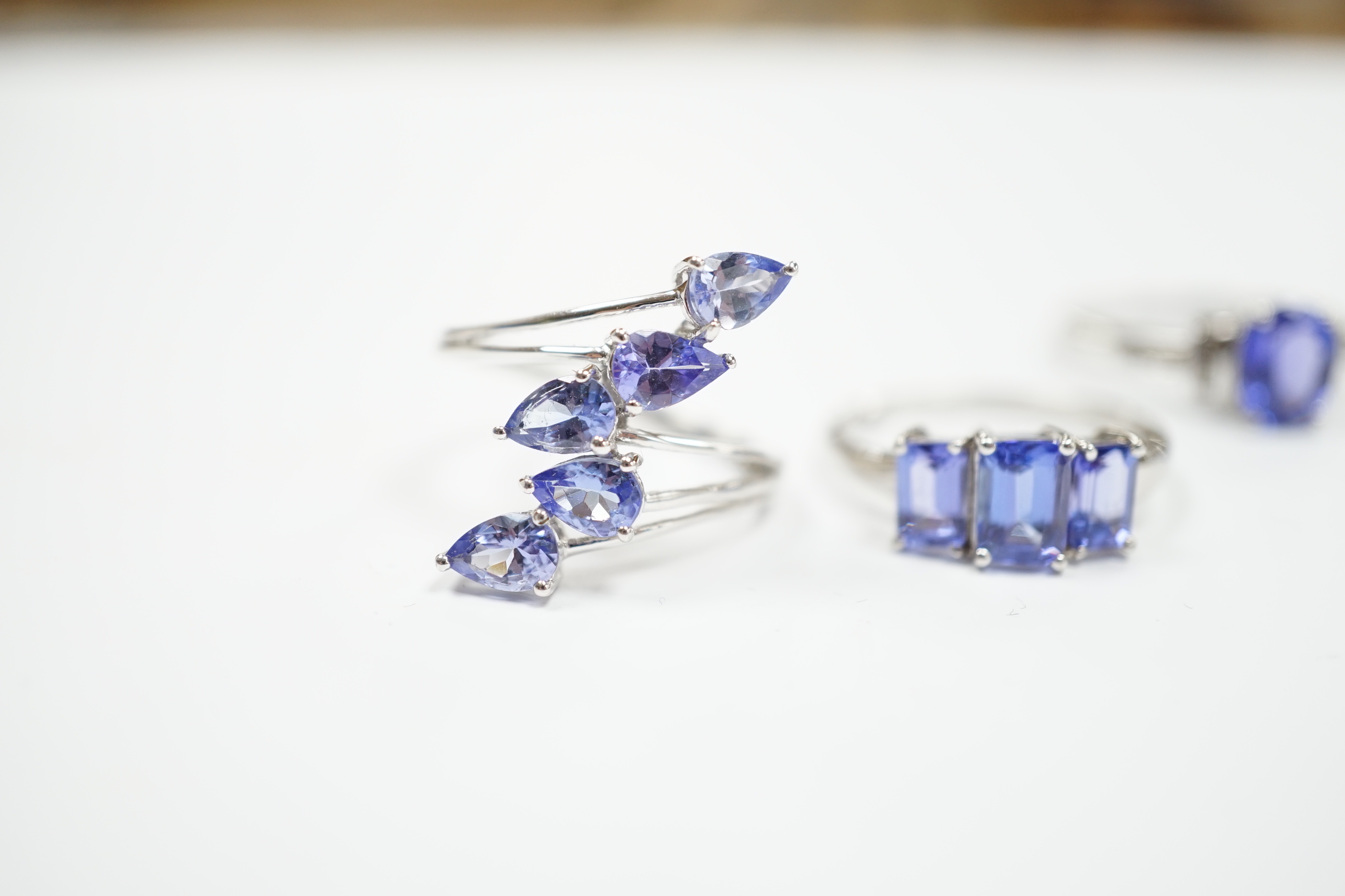 Three assorted modern 9ct white gold and tanzanite set dress rings, gross weight 8.4 grams.